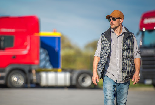 man walking with trucks in background