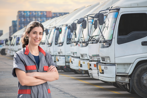 woman smiling in front of trucks